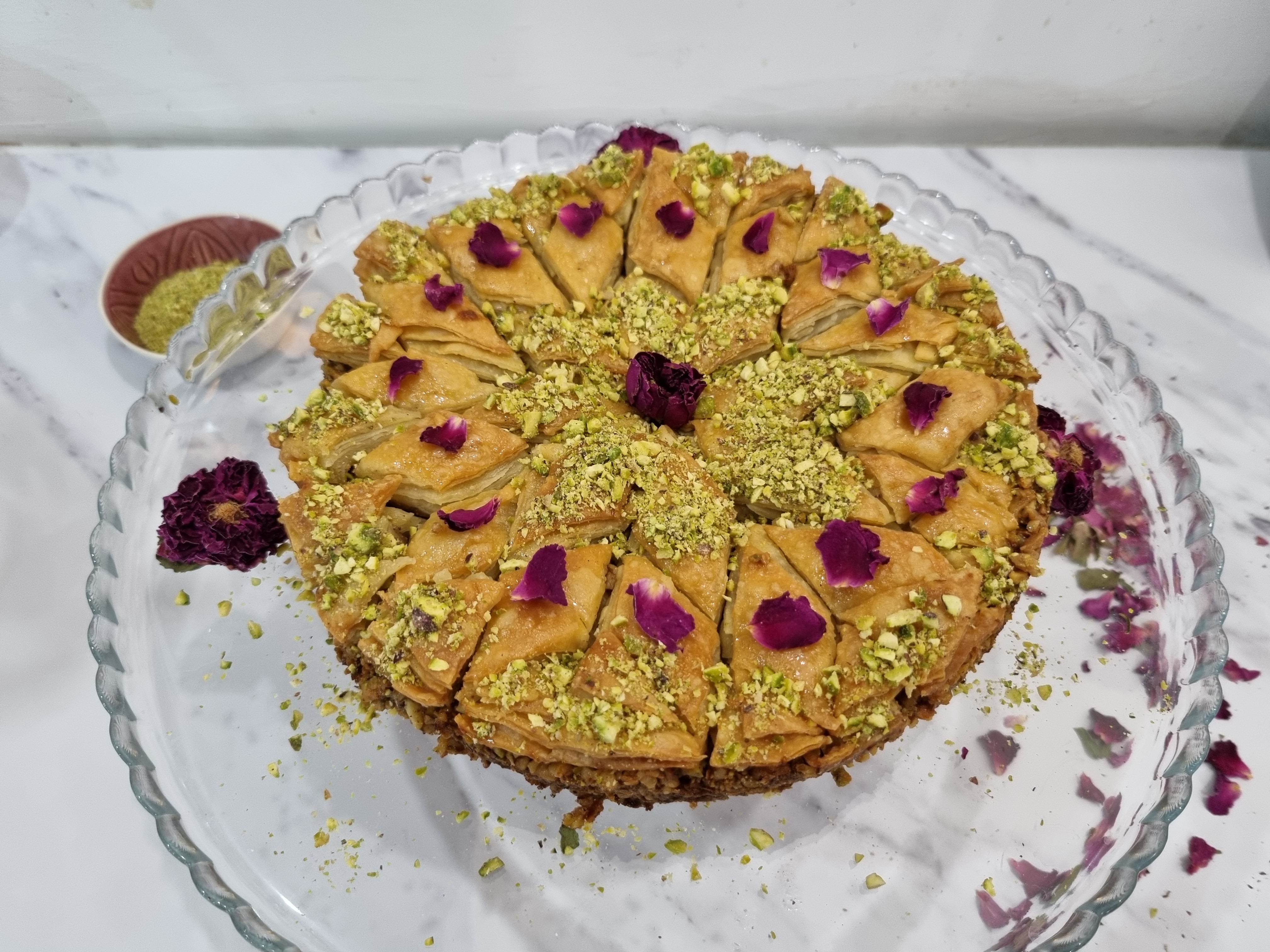 Finished picture of homemade baklava with pistachios and rose petals